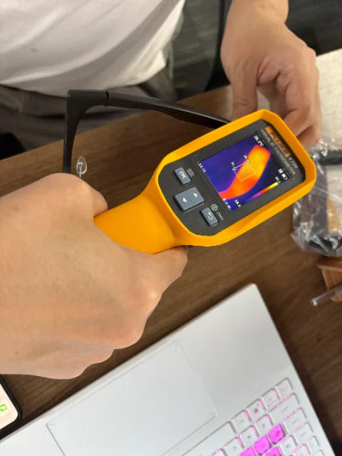 A C100 temple beside a visual infrared thermometer during a development observation